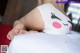 A woman laying on top of a bed wearing a bunny underwear.