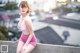 A woman in a pink lingerie sitting on a ledge.