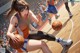 A woman in a basketball uniform dribbling a basketball on a court.