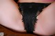 A close up of a woman's butt in a black thong.