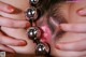 A close up of a woman's face with a bunch of balls in her mouth.